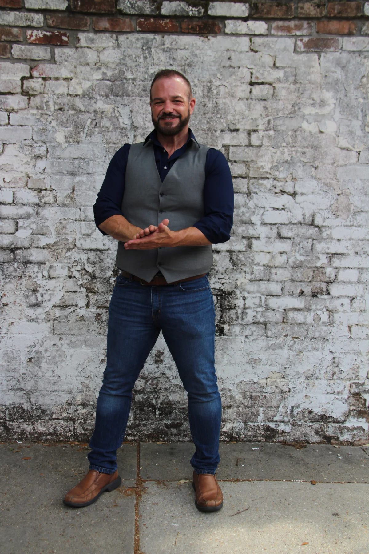 Lantz Savage standing in front of a brick wall